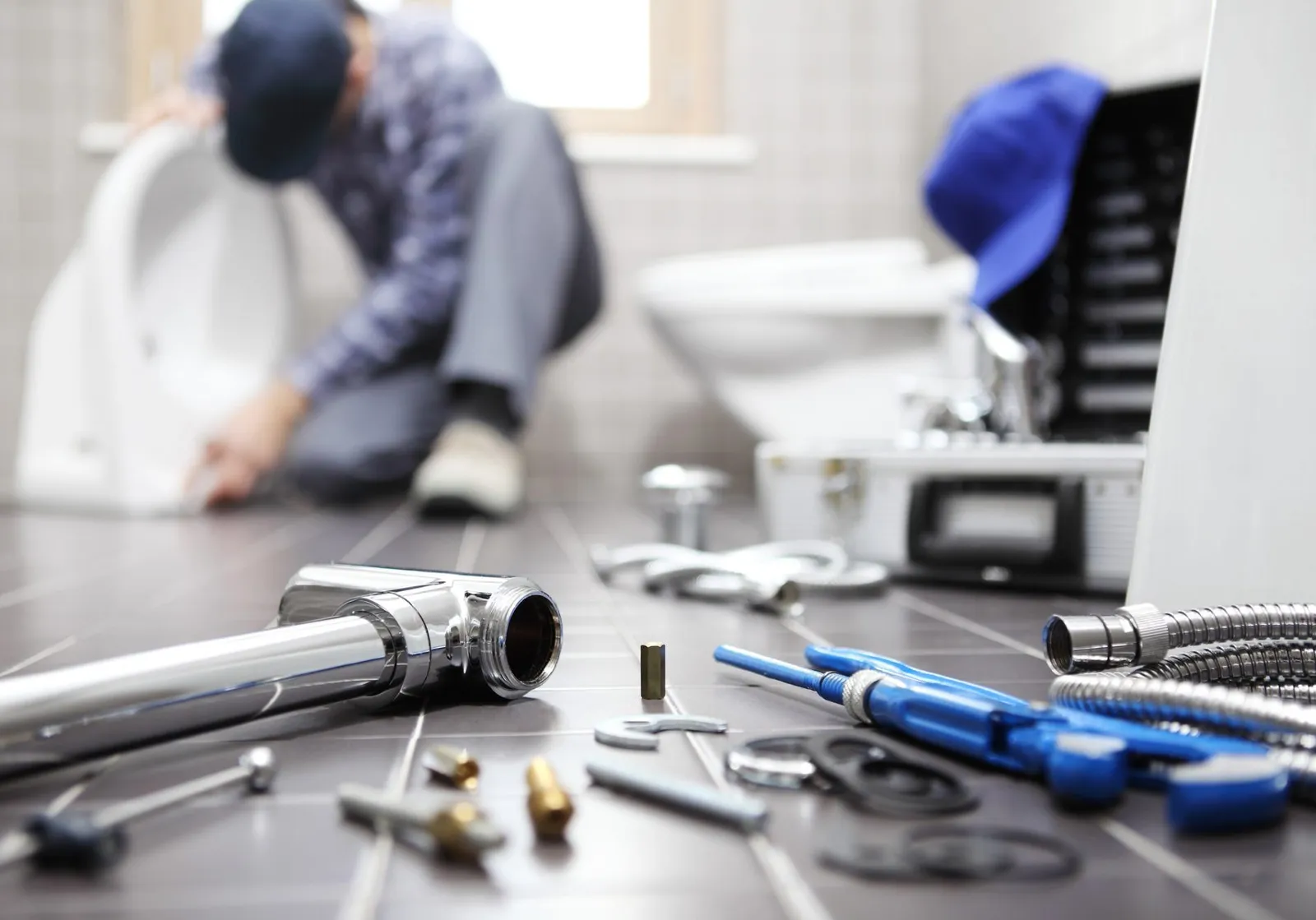 Plumber at work in a bathroom, plumbing repair service, assemble and install concept